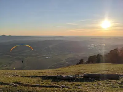 a person flying a kite on top of a hill at Apartment Senik in Grgar