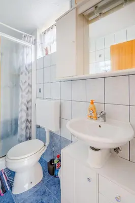 a bathroom with a toilet and a sink at Apartma Vučič in Bovec