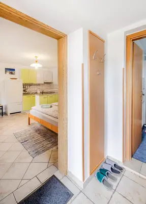 a room with a bedroom with a bed and a kitchen at Apartma Vučič in Bovec