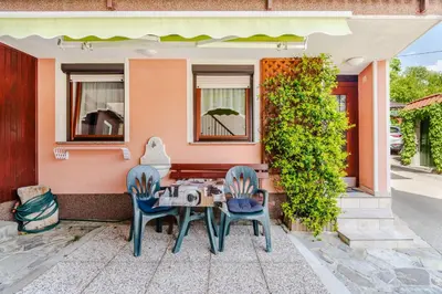a table and chairs outside of a house at Apartma Vučič in Bovec