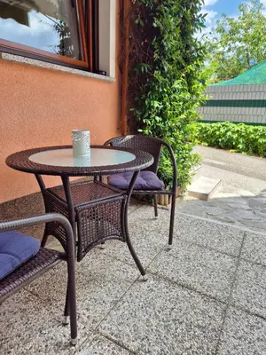 a table and two chairs with a coffee cup on it at Apartma Vučič in Bovec