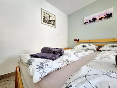 a bedroom with two twin beds with towels on them at Apartma Vučič in Bovec