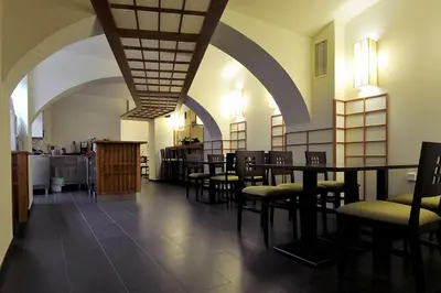 a dining room with tables and chairs in a building at Miyabi 1 in Maribor