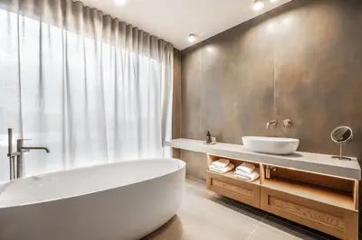 a bathroom with a white tub and a sink at Hiša Marija House in Miklavž pri Ormožu