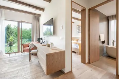a bathroom with a sink and a tub and a bedroom at Hiša Marija House in Miklavž pri Ormožu