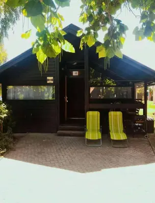 two yellow chairs sitting in front of a building at BRUNARICA VINTAGE 83 - nastanitev z vključenimi kopalnimi kartami - with Thermal Riviera Tickets included in Brežice