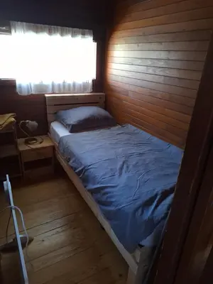 a small bed in a room with a window at BRUNARICA VINTAGE 83 - nastanitev z vključenimi kopalnimi kartami - with Thermal Riviera Tickets included in Brežice