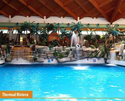 a large swimming pool with a waterfall in a hotel at BRUNARICA VINTAGE 83 - nastanitev z vključenimi kopalnimi kartami - with Thermal Riviera Tickets included in Brežice