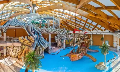 a large indoor water park with a water slide at BRUNARICA VINTAGE 83 - nastanitev z vključenimi kopalnimi kartami - with Thermal Riviera Tickets included in Brežice