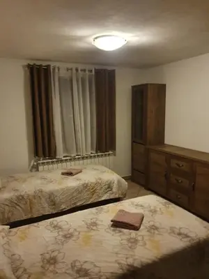 a bedroom with two beds and a dresser and a window at Apartment with one room-LUCIA in Selo