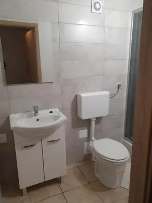 a white bathroom with a toilet and a sink at Apartment with one room-LUCIA in Selo