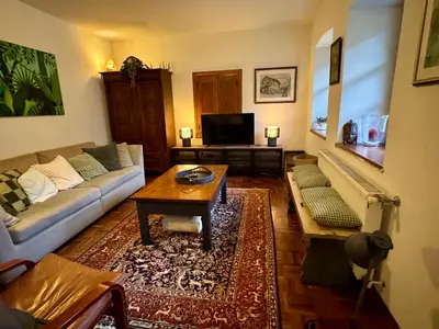 a living room with a couch and a coffee table at Hisa Betin 4 bedroom Holiday Home in Soca Valley in Tolmin
