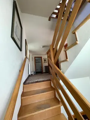 a staircase in a house with wooden railings at Hisa Betin 4 bedroom Holiday Home in Soca Valley in Tolmin