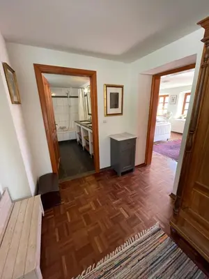 a living room with a wooden floor and a hallway at Hisa Betin 4 bedroom Holiday Home in Soca Valley in Tolmin