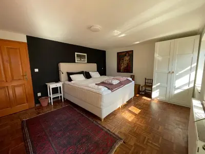 a bedroom with a bed and a black wall at Hisa Betin 4 bedroom Holiday Home in Soca Valley in Tolmin