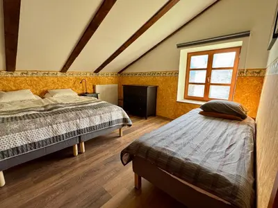 a bedroom with two beds and a window at Hisa Betin 4 bedroom Holiday Home in Soca Valley in Tolmin