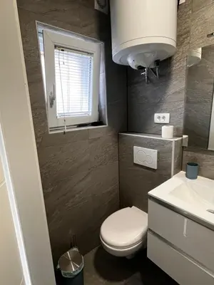 a small bathroom with a toilet and a sink at Apartmaji MAS 3 in Ljubljana