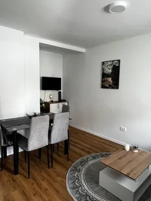 a living room with a dining table and a desk at Apartmaji MAS 3 in Ljubljana