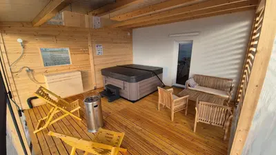 a screened in porch with a grill and chairs at Hiša Ispira in Moravske Toplice