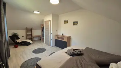 a bedroom with a bed and a desk in it at Hiša Ispira in Moravske Toplice