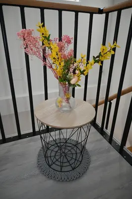 a vase of flowers on a table on a balcony at Hiša Ispira in Moravske Toplice