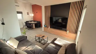 a living room with a couch and a flat screen tv at Hiša Ispira in Moravske Toplice