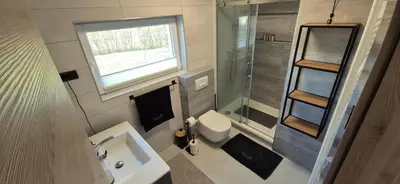 a small bathroom with a sink and a toilet at Hiša Ispira in Moravske Toplice