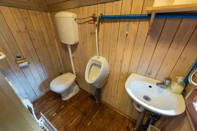 a small bathroom with a toilet and a sink at Chalet Pehta Velika Planina in Stahovica