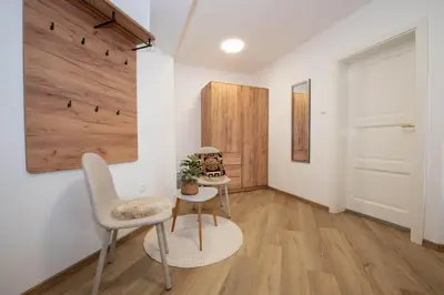 a room with a table and two chairs and a door at Linasi Resort Slovenia in Nazarje