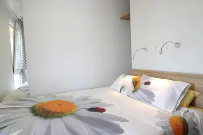a bedroom with a bed with two flowers on it at Saxida Wine Estate in Zalošče