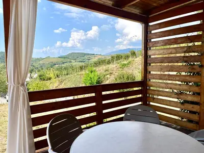 a table and chairs in a room with a window at Saxida Wine Estate in Zalošče