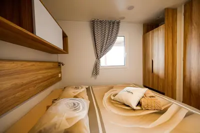a bedroom with two beds and a window at Saxida Wine Estate in Zalošče
