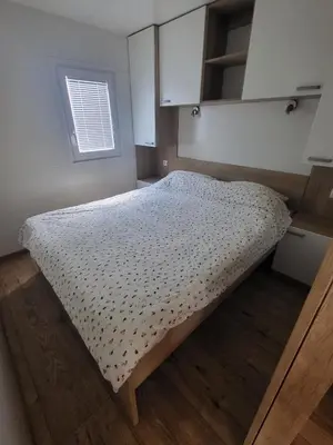 a bed in a small room with a window at Pavel Cottage with 2 Thermal Riviera Tickets in Moravske Toplice