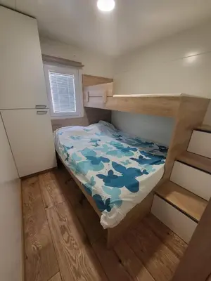 a small bedroom with a bunk bed in a house at Pavel Cottage with 2 Thermal Riviera Tickets in Moravske Toplice