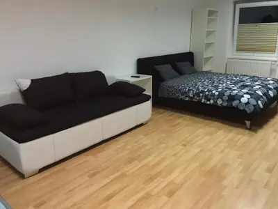 a bedroom with a couch and a bed in it at Apartments Abc Ljubljana in Ljubljana