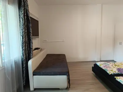 a room with a bench and a bed in it at Apartments Abc Ljubljana in Ljubljana