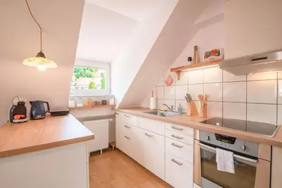 a kitchen with white cabinets and a sink at Trubarjeva 12 - The view in Ljubljana