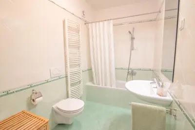 a white bathroom with a sink and a toilet at Trubarjeva 12 - The view in Ljubljana
