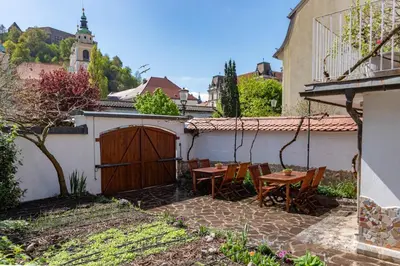 a patio with a table and chairs in a yard at Trubarjeva 12 - The view in Ljubljana