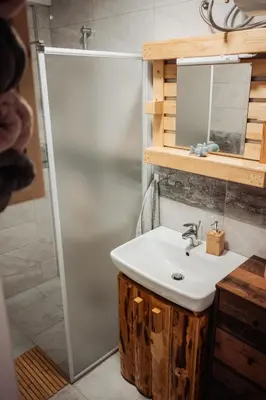 a bathroom with a sink and a shower at Koča ob ribniku in Ponikva