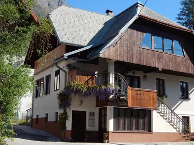 a house with flowers on the balconies of it at Apartmaji Boka in Bovec