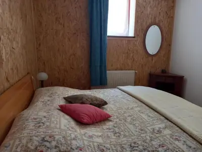 a bedroom with a bed with two pillows on it at Apartmaji Boka in Bovec