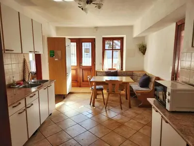 a kitchen with a table and a dining room at Apartmaji Boka in Bovec