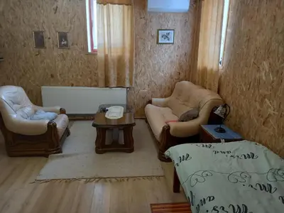 a living room with two chairs and a table at Apartmaji Boka in Bovec