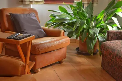 a living room with a chair with a pillow on it at Apartmaji Boka in Bovec