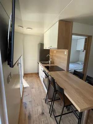 a small kitchen with a wooden table in a room at Pavel 1 Cottage with 2 Thermal Riviera Tickets in Moravske Toplice