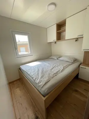 a bed in a small room with a window at Pavel 1 Cottage with 2 Thermal Riviera Tickets in Moravske Toplice