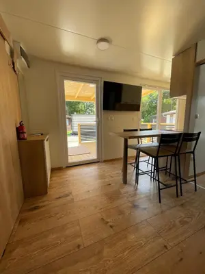 a kitchen and dining room with a table and chairs at Pavel 1 Cottage with 2 Thermal Riviera Tickets in Moravske Toplice