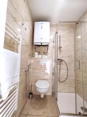 a bathroom with a toilet and a shower at Apartment Twin 1 in Ljubljana