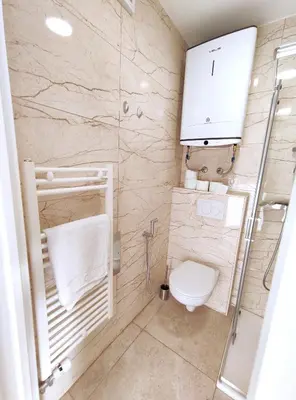 a bathroom with a toilet and a shower at Apartment Twin 1 in Ljubljana
